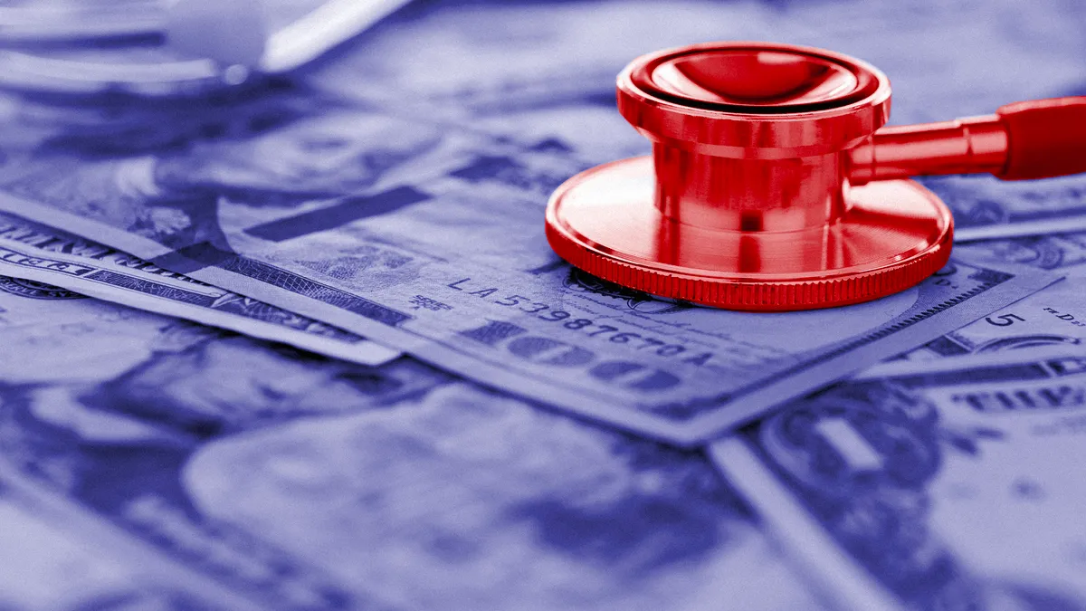 a picture of a red stethoscope on top of a US billed money.