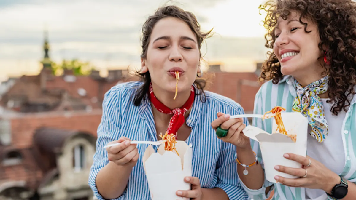Women eating takeout on a rooftop