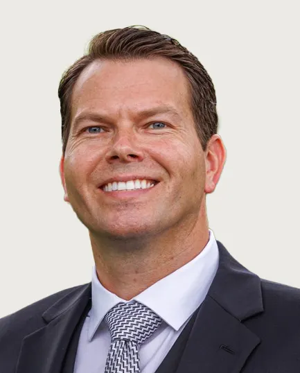 Headshot of a man in business attire.