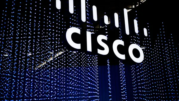 A logo sits illuminated outside the Cisco booth at the SK telecom booth on day 1 of the GSMA Mobile World Congress on February 28, 2022 in Barcelona, Spain.