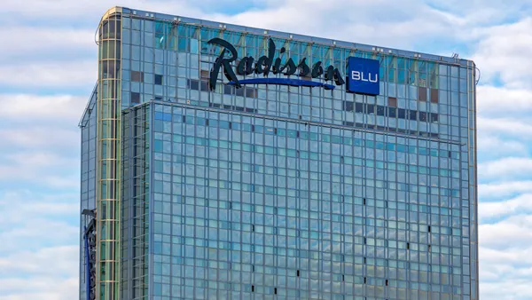 A close up of a Radisson Blu Hotel glass skyscraper in Oslo, Norway
