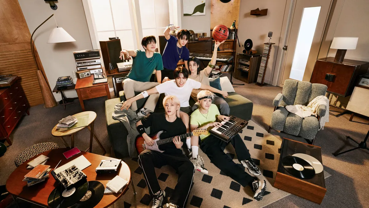 A group of people in Under Armour clothes sit in a living room.