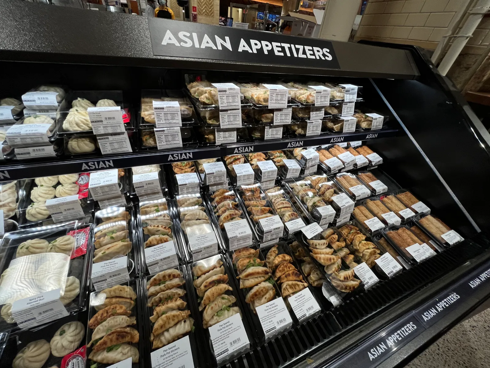 Packaged Asian appetizers at a grocery store.