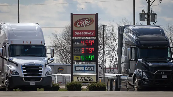 A digital sign shows fuel prices between two tractors at a truck stop in Illinois.