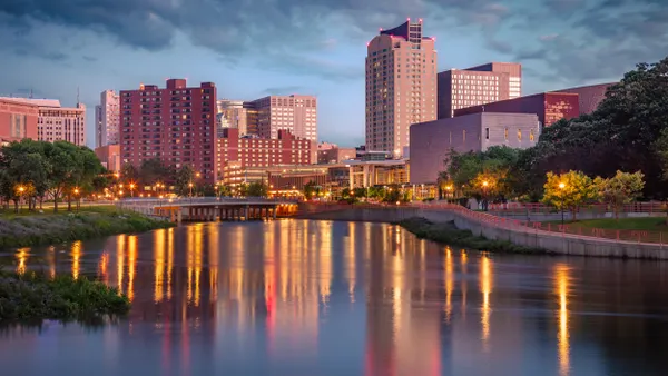 A city skyline with a body of water in the foreground.