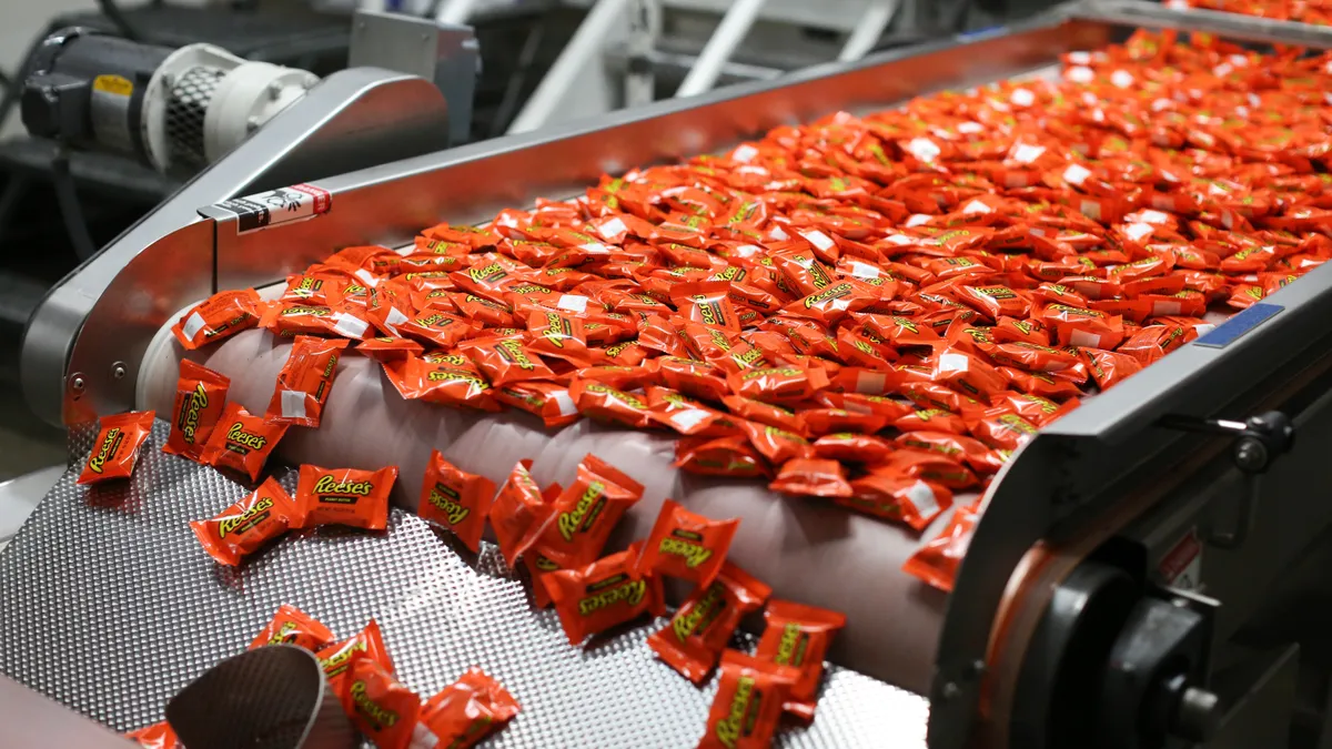 Reese's candies funnel through a Hershey production line.