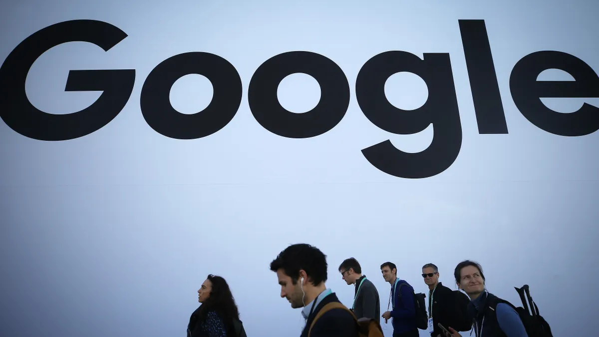 People walk past the Google pavilion at CES 2020 at the Las Vegas Convention Center on January 8, 2020 in Las Vegas, Nevada.