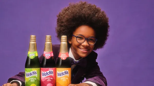 Child actor Paxton Beau Bazile poses with bottles of Welch's Sparkling Juices