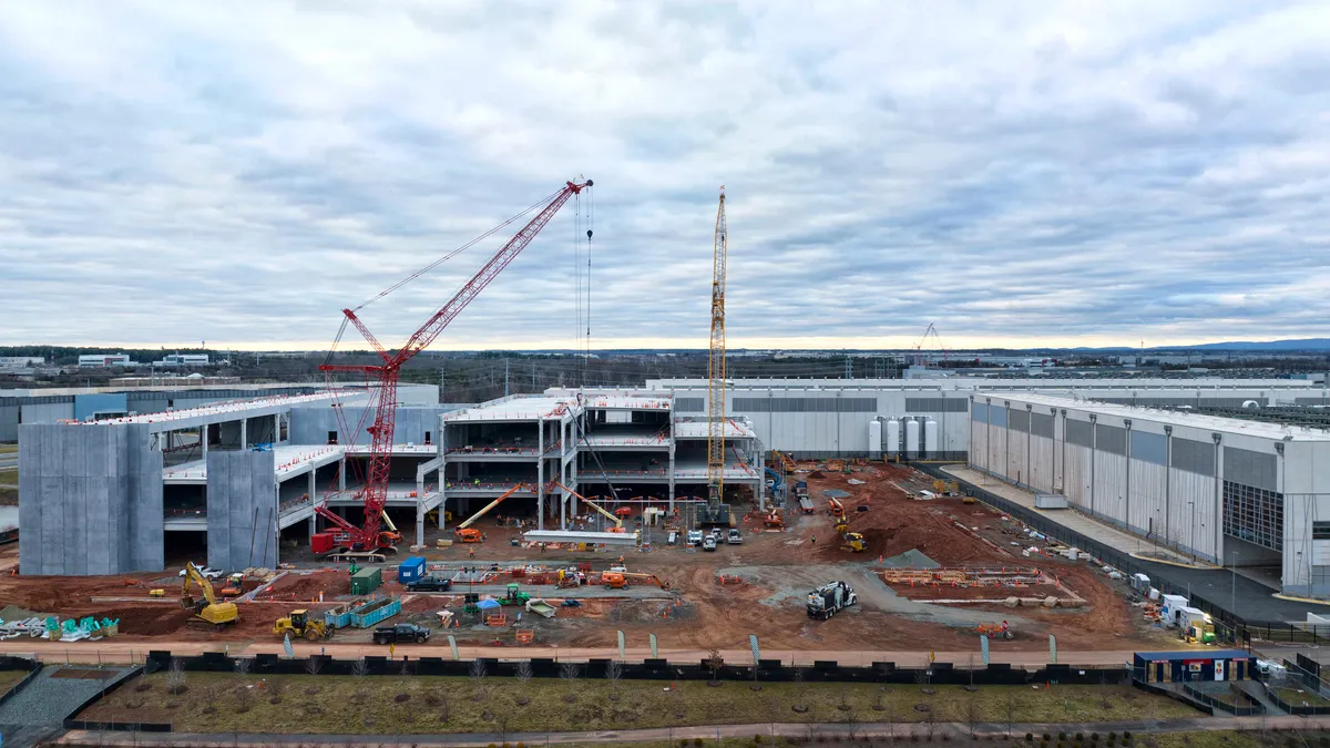 A construction site with two cranes.