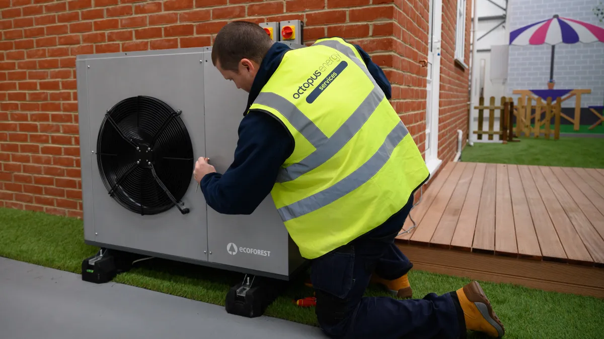 An engineer checks the installation of a Daikin 7KW heat pump on a model house within the Octopus Energy training facility on November 02, 2021 in Slough, England.