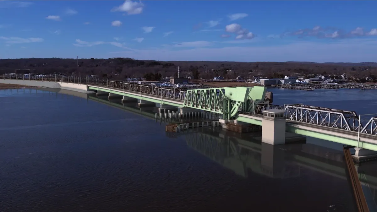 A rendering shows the design of a new green railroad bridge over the Connecticut River.