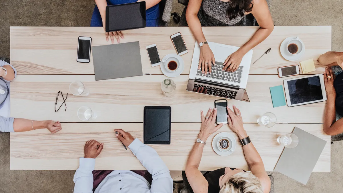 Group of people in meeting around boardroom table