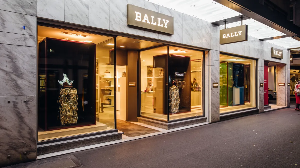 Exterior view of a Bally Boutique fashion store at night in Zurich, Switzerland.