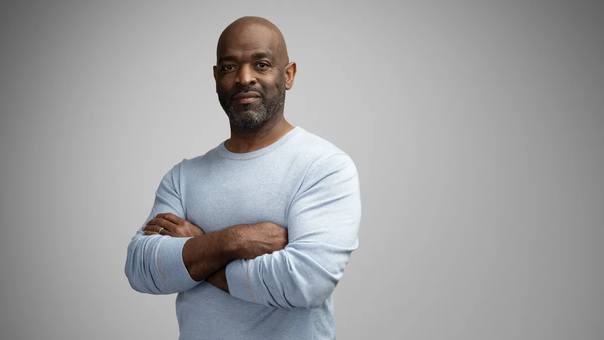 A headshot of Nike executive Craig Williams against a grey background.