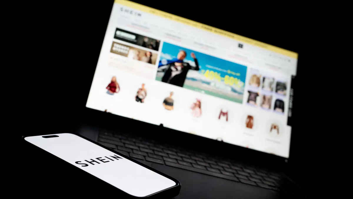 A laptop displaying the Shein website and a phone displaying the Shein logo.
