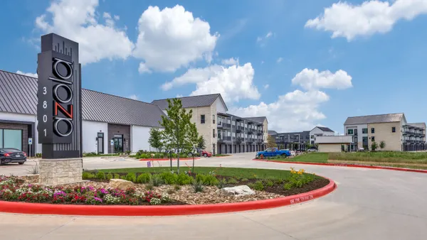 A circular driveway next to an apartment building.