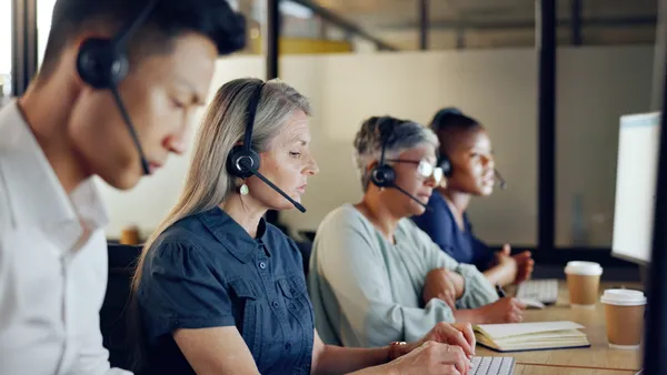 Call center agents handle customer service at desks