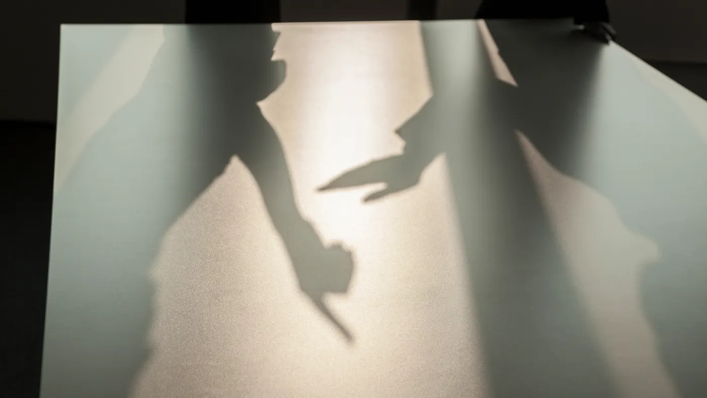 Shadow of two business people arguing and gesturing on the floor of the office
