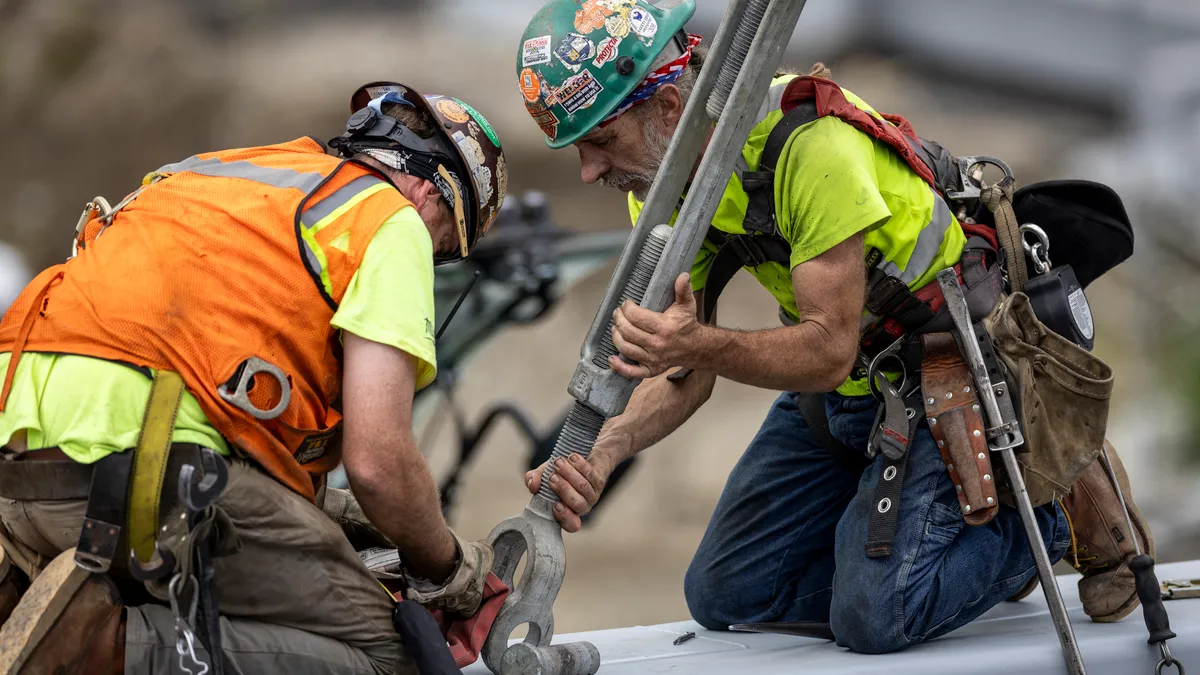 Workers prepare to lift a new pedestrian bridge into place at the Stamford Transportation Center on August 26, 2023 in Stamford, Connecticut.