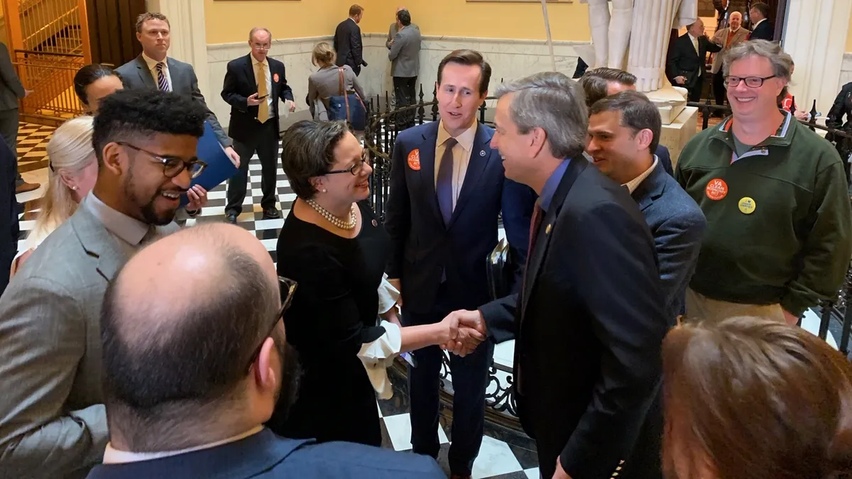 Senator Jennifer McClellan shaking hands after the passage of her Virginia Clean Economy Act.