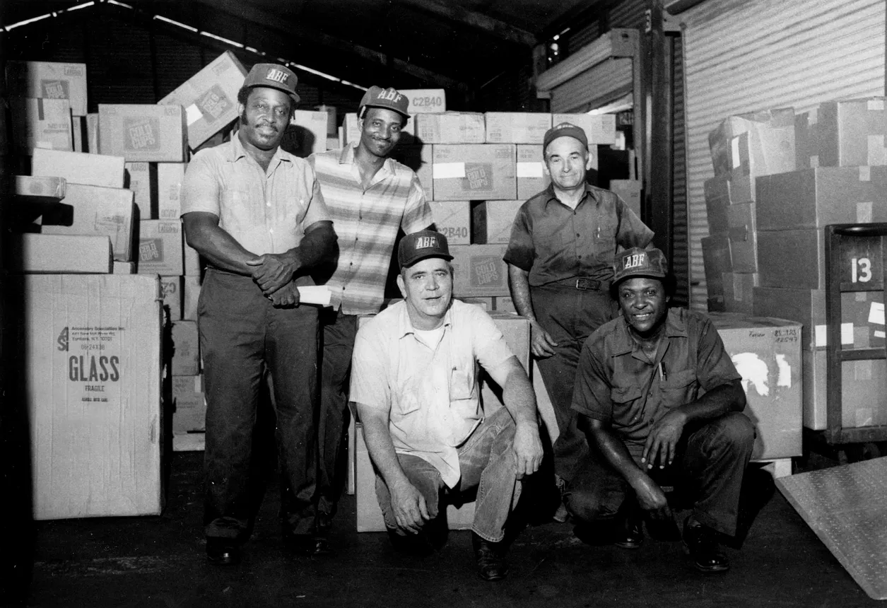 ABF Freight workers pose with freight in a 1983 photo.