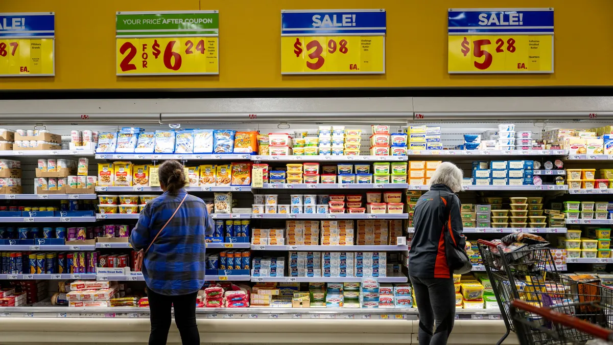 Two customers shop at an H-E-B grocery store.