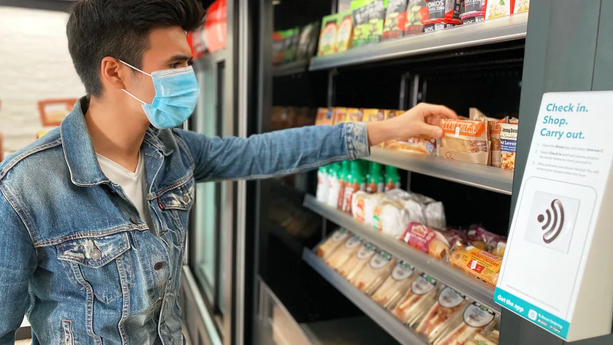 Customer in retail store equipped with Standard cashierless technology