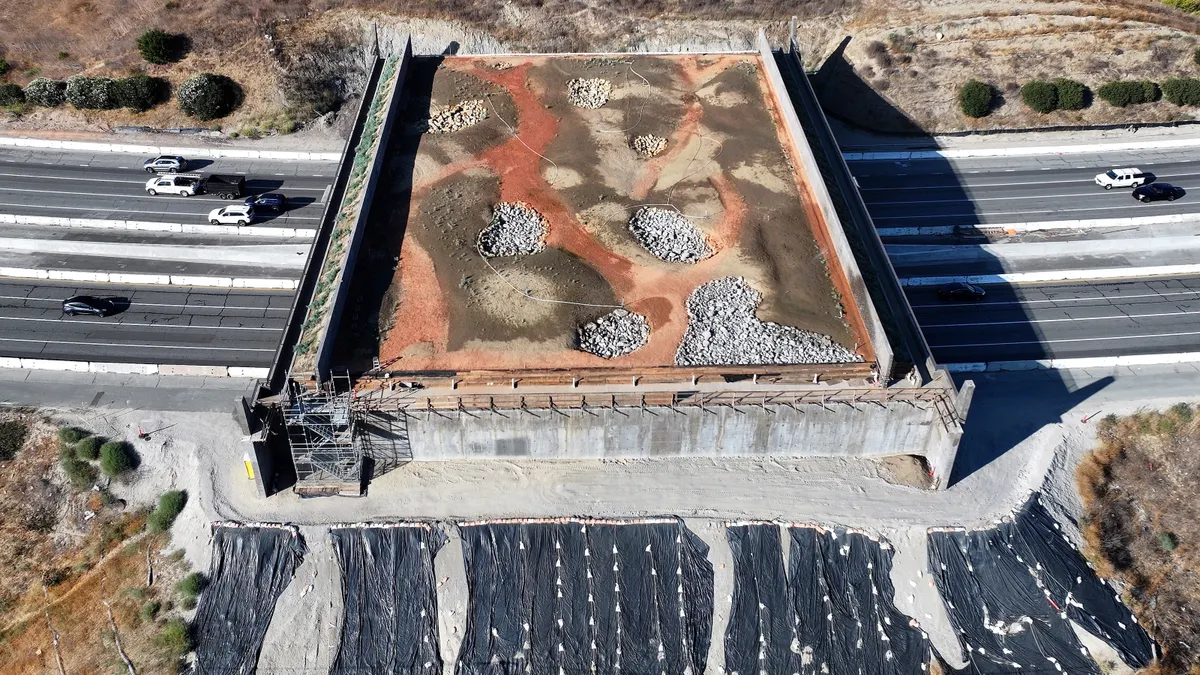 An aerial view of construction of the Wallis Annenberg Wildlife Crossing