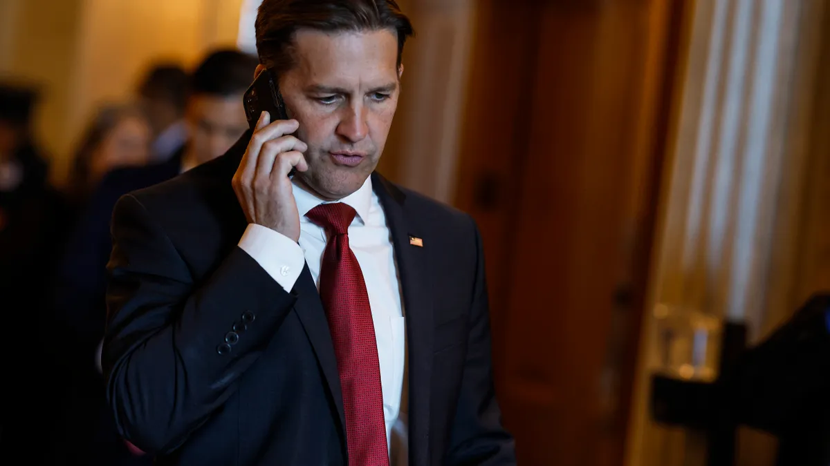 U.S. Sen. Ben Sasse speaks on a mobile phone.