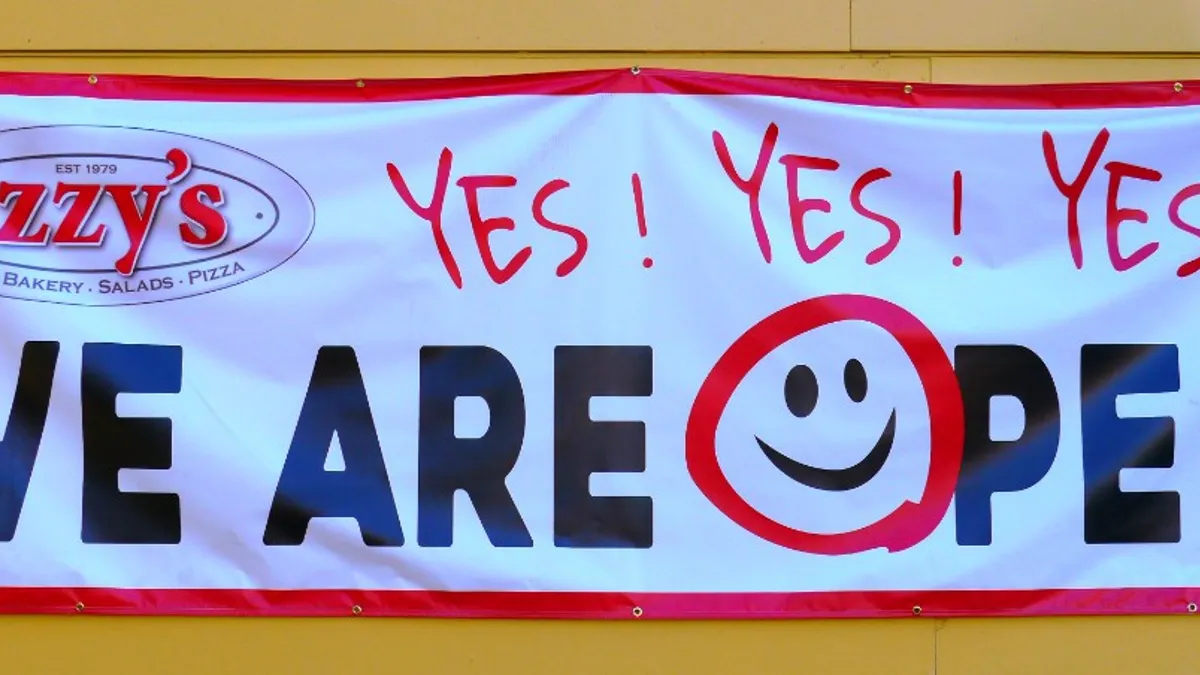 A banner outside Izzy's Restaurant in Eugene, Oregon, during the coronavirus pandemic in 2020.