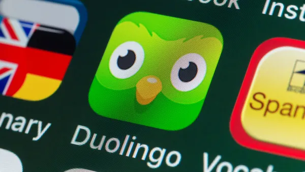 The buttons of the app Duolingo, surrounded by Dictionary, Vocabulary, Facebook on an iPhone screen.