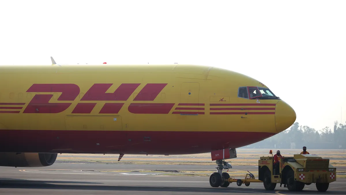 A DHL airplane is pulled at Benito Juarez International Airport on December 23, 2020 in Mexico City, Mexico.