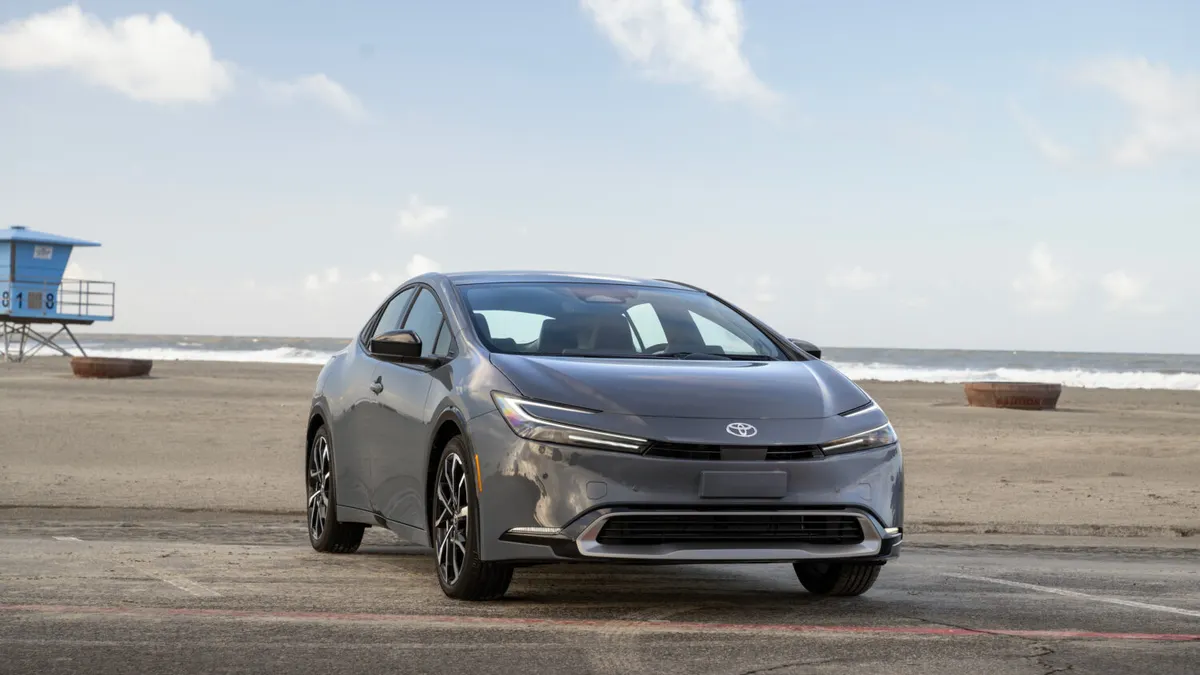 A gray 2026 Toyota Prius plug-in hybrid parked near a beach.