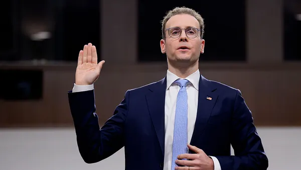 Michael Selig, Commodity Futures Trading Commission chair, holds up his right hand while speaking during a congressional hearing.