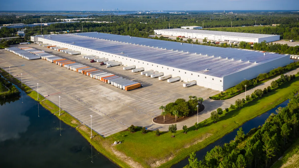 An aerial view of an appliance distribution center surrounded by body of water.