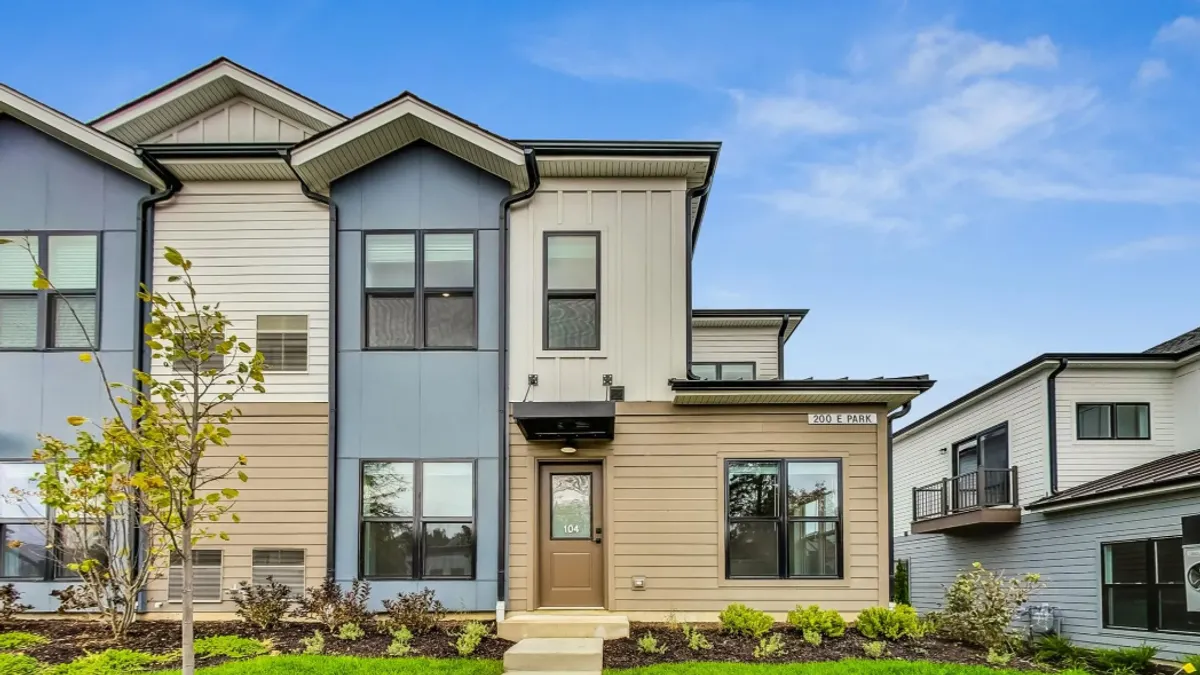 A single family home surrounded by a green yard