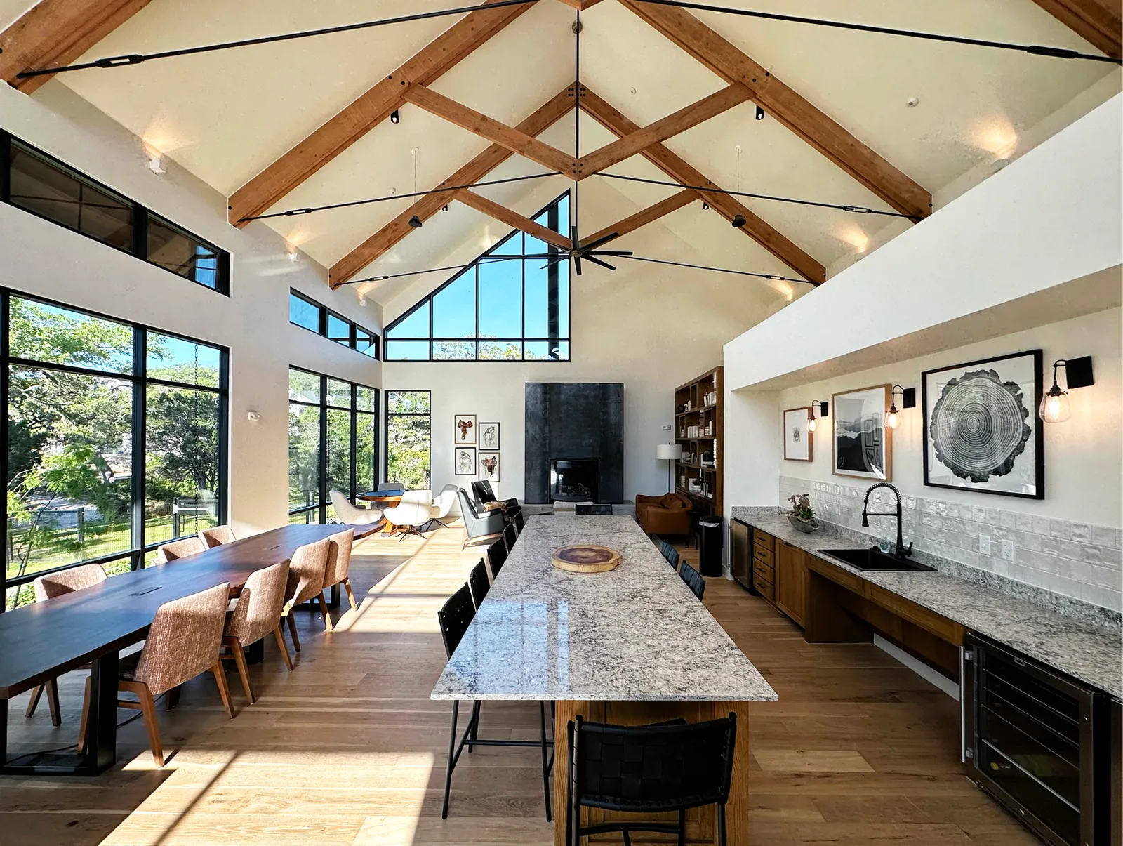 A room with a peaked roof, tables and chairs.