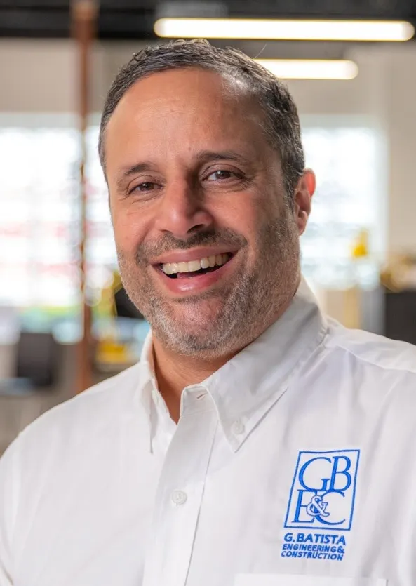 Headshot of a man in professional attire.