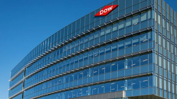 A corporate building with glass windows and a red and white Dow logo sign on top right corner.