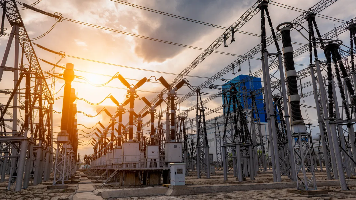 A high voltage substation under sunset.