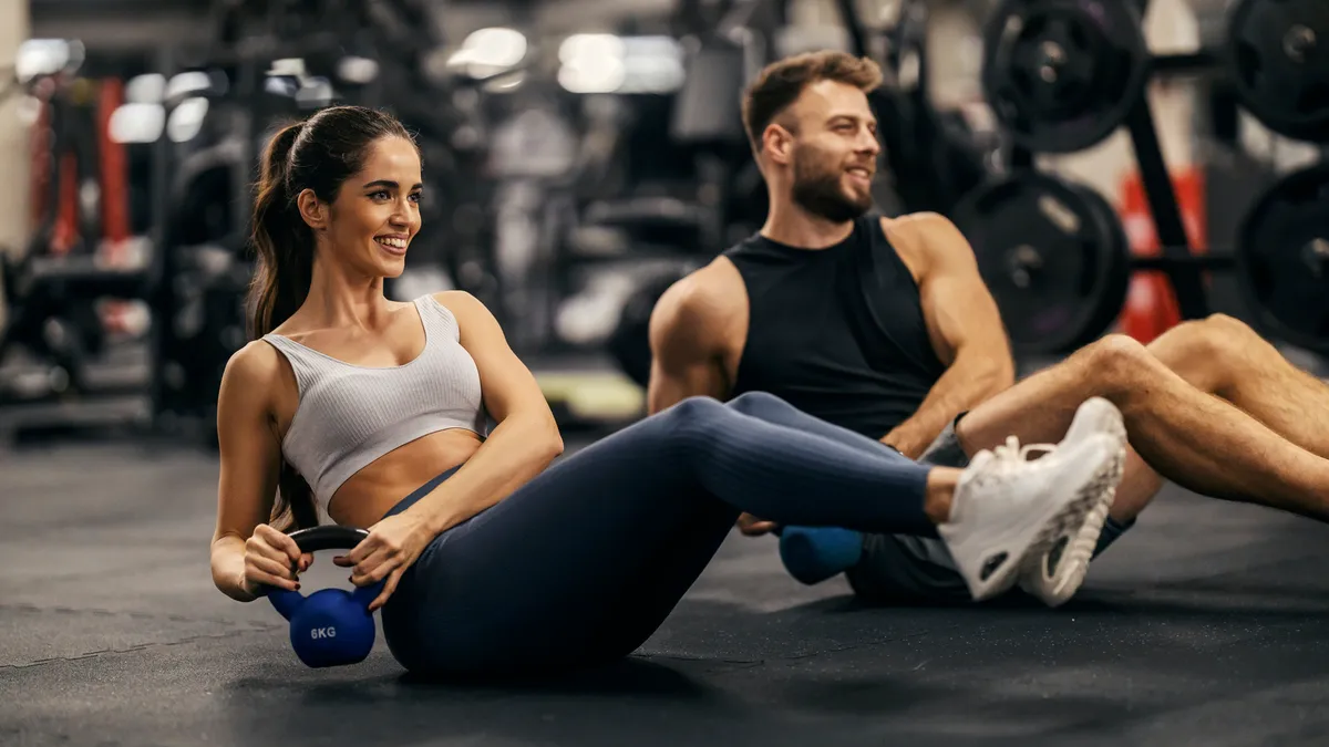 Shot of couple exercising in a gym