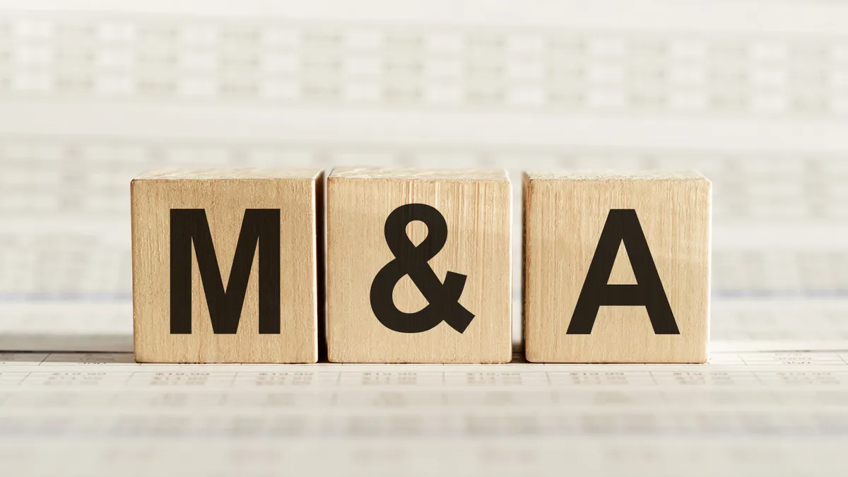 Wooden cubes that spell out "M&A"