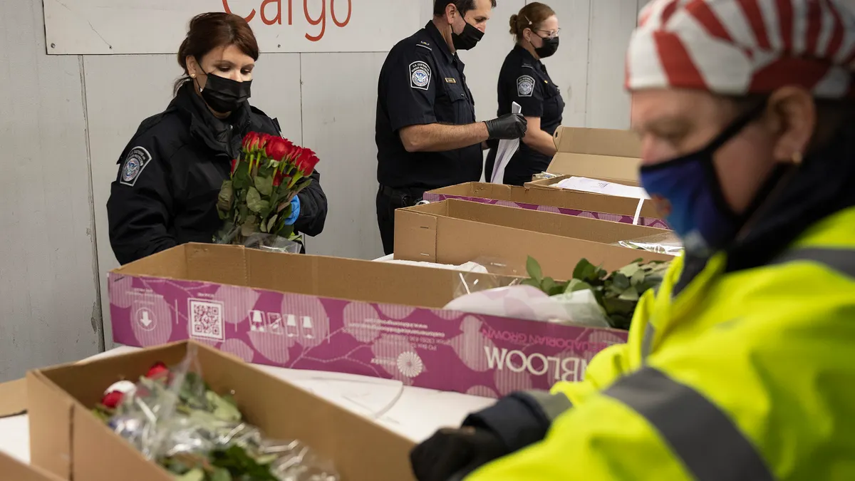 U.S. Customs and Border Protection agriculture specialists inspect flowers at Miami International Airport on Feb. 8, 2022.