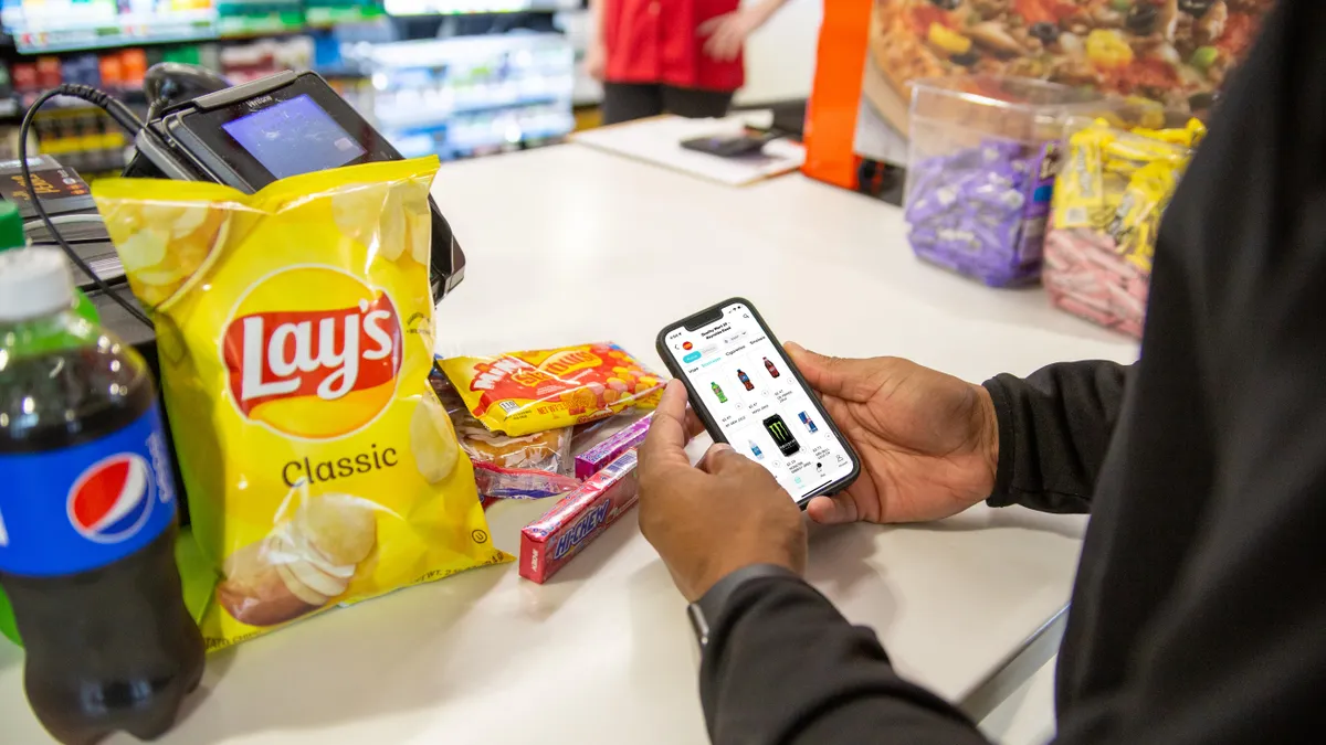 A photo of a person using the Quality Mart app to order ahead.