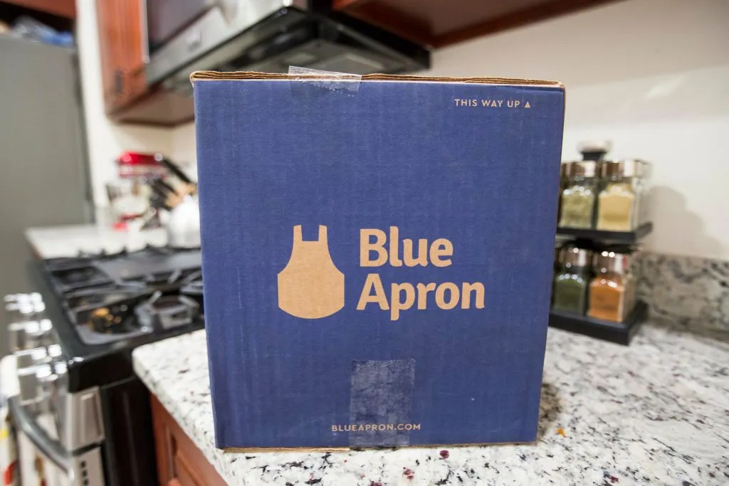 A Blue Apron box on a kitchen counter.