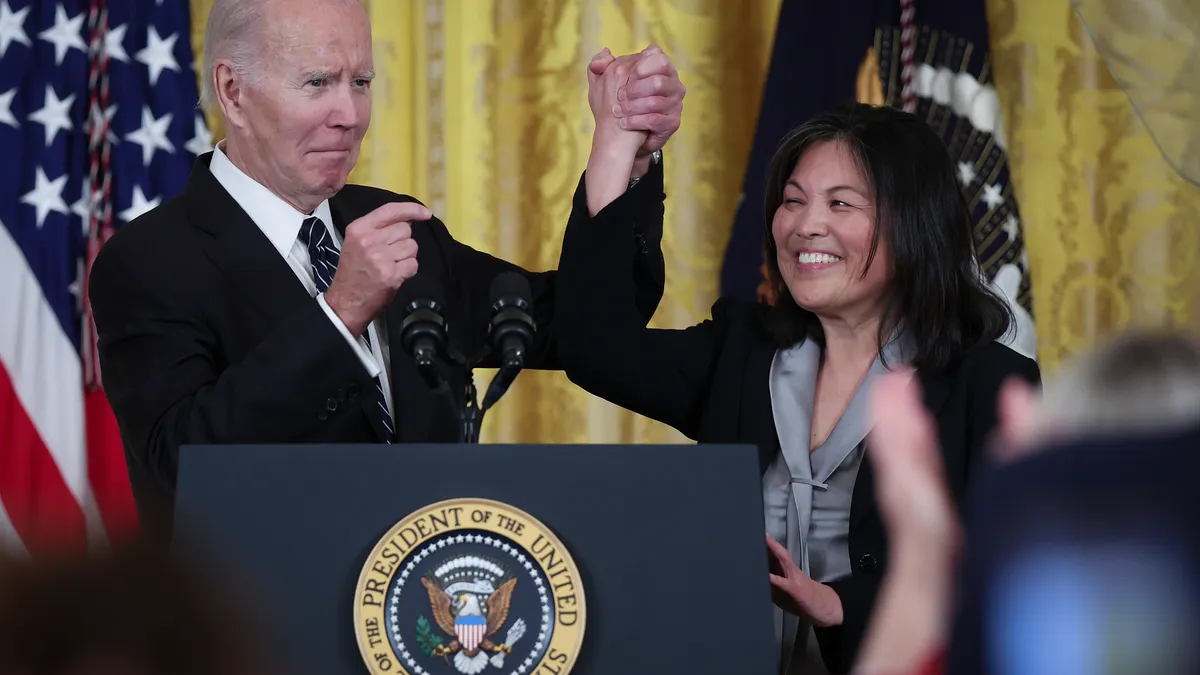 U.S. President Joe Biden links arms with Julie Su, his nominee to be the next Secretary of Labor