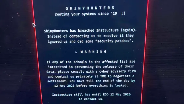 A screenshot of a message from ShinyHunters on a laptop screen.