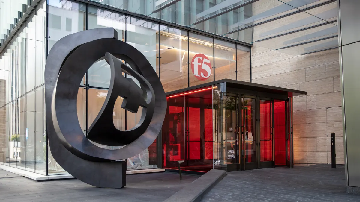 The entry to a large glass building with the F5 corporate logo is pictured.