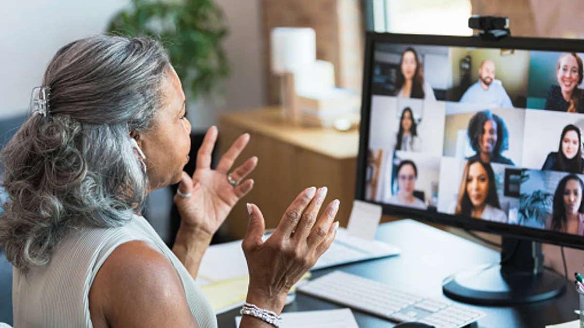 An employee speaks during a meeting on a SaaS video conferencing solution.