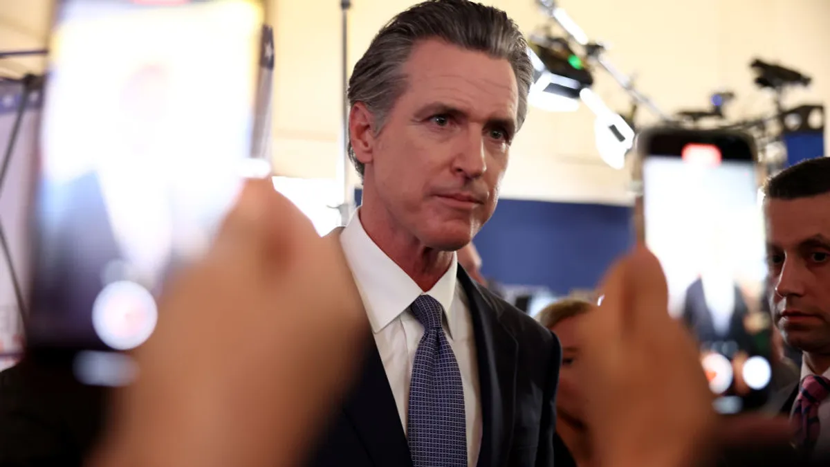 California Gov. Gavin Newsom talks to reporters following the FOX Business Republican Primary Debate in September 2023.